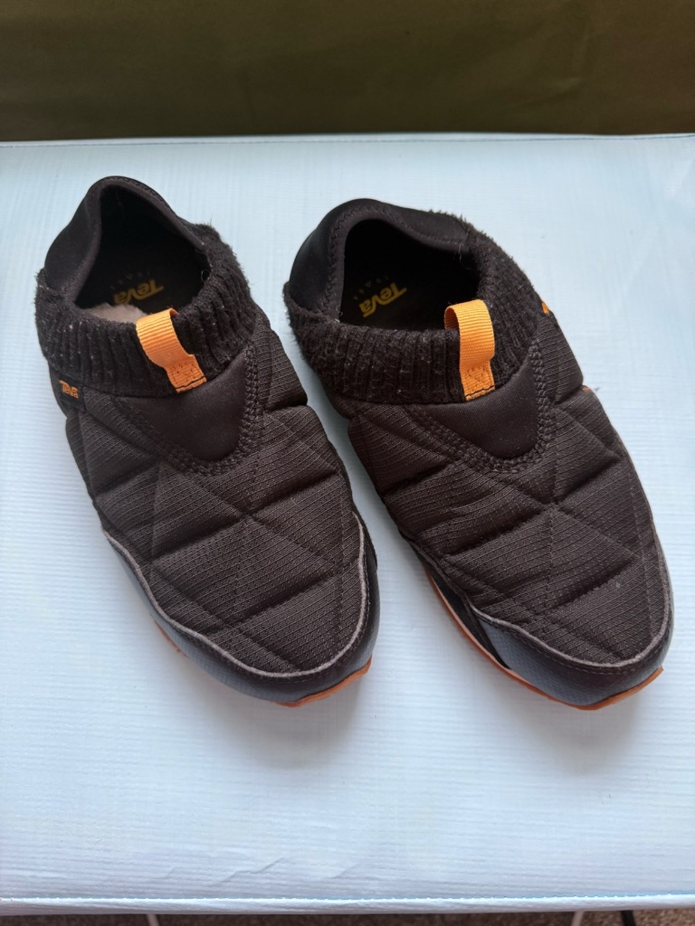 Teva Women’s 7 Black Quilted Slip-On Shoes with Orange Pull Tabs